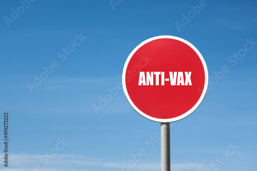 'Anti-vax' sign in round red frame. Blue sky is on background © Poliorketes
