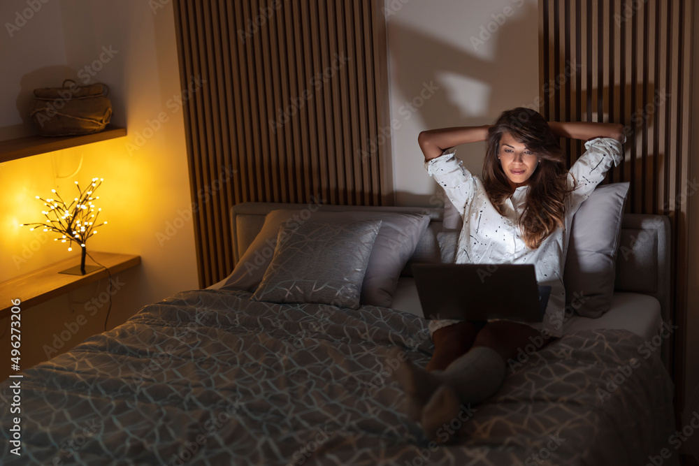 Woman watching movie in bed Woman watching movie in bed