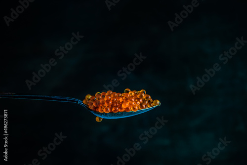 Close-up of a spoonful of red trout caviar photo