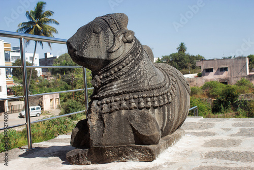 Ruined  stone Sculpture of Nandi outside of Sangameshwar Temple, Saswad, Maharashtra, India photo
