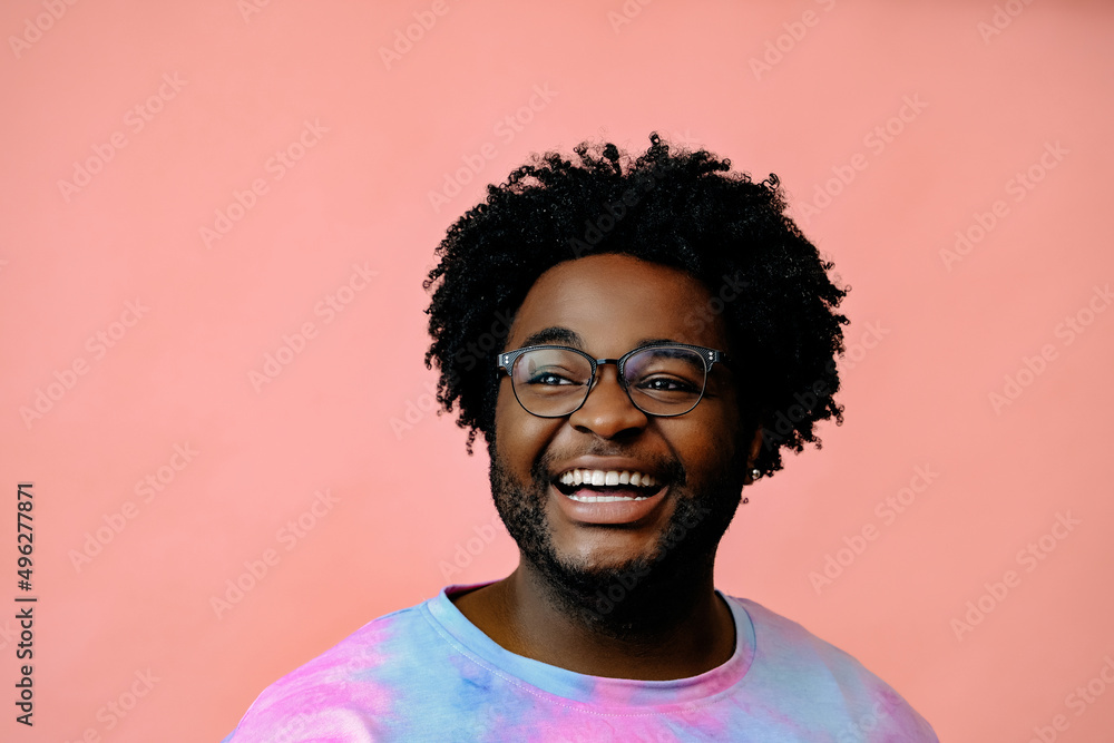 young happy african american man posing in the studio over pink background young happy african american man posing in the studio over pink background