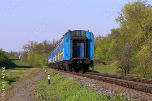 small passenger train passing by railroad