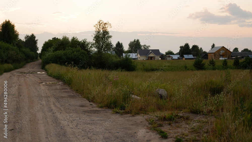 Fototapeta premium Beautiful rustic summer landscape with road. Old wooden log houses. Vologda region