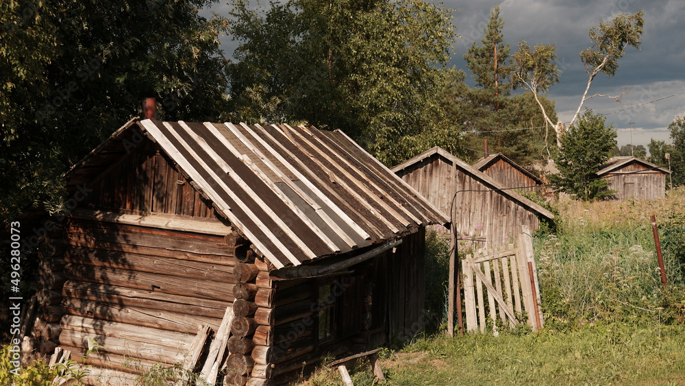 Beautiful rustic summer landscape. Old wooden log houses. Vologda region