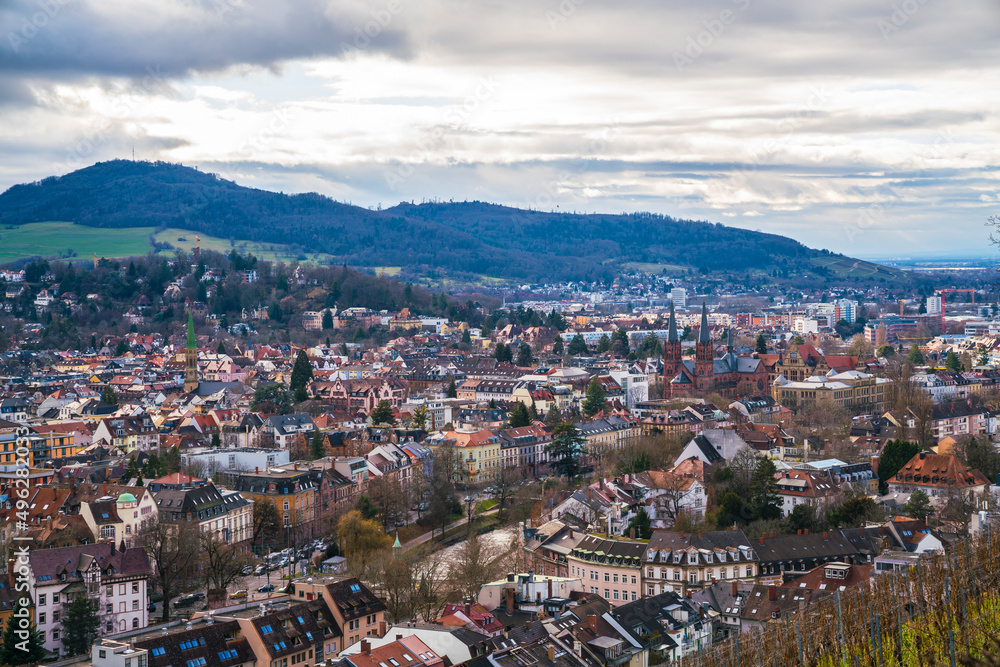 Germany, Freiburg im Breisgau city houses downtown, view above the skyline of the medieval town, streets and churches with sun