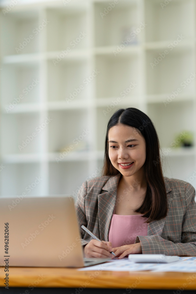 Asian business women using notebook and smiling happy for working Asian business women using notebook and smiling happy for working