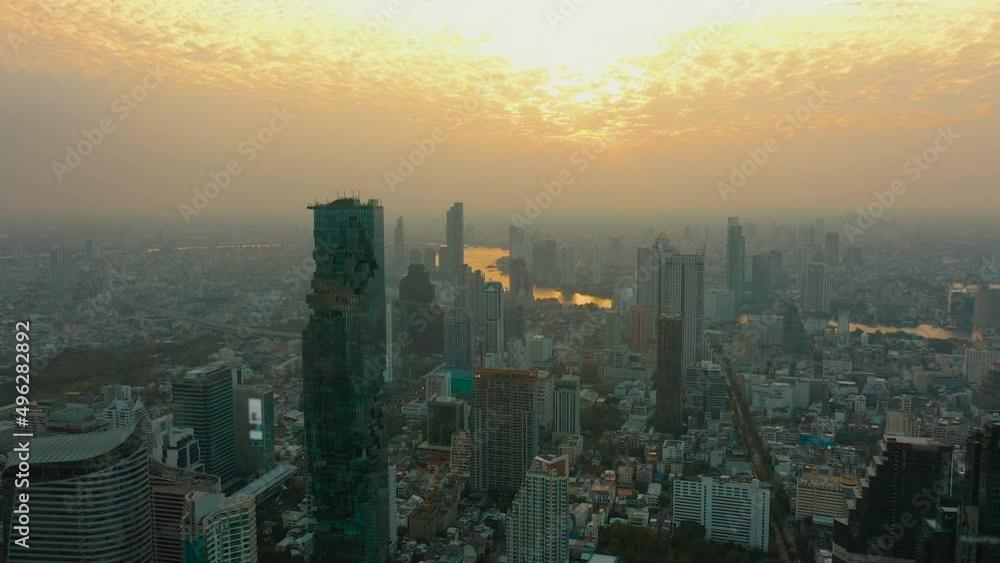 Aerial view of Bangkok city, Thailand at golden hour sunset. Chao Phraya river, financial district and business centers, skyscrapers and high-rise office buildings, street highways Aerial view of Bangkok city, Thailand at golden hour sunset. Chao Phraya river, financial district and business centers, skyscrapers and high-rise office buildings, street highways