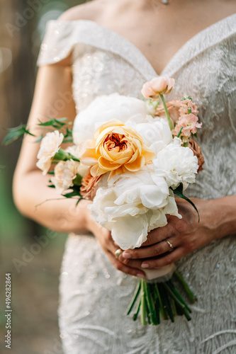 closeup stylish bouquet of white orchids in the hands of bride

 photo