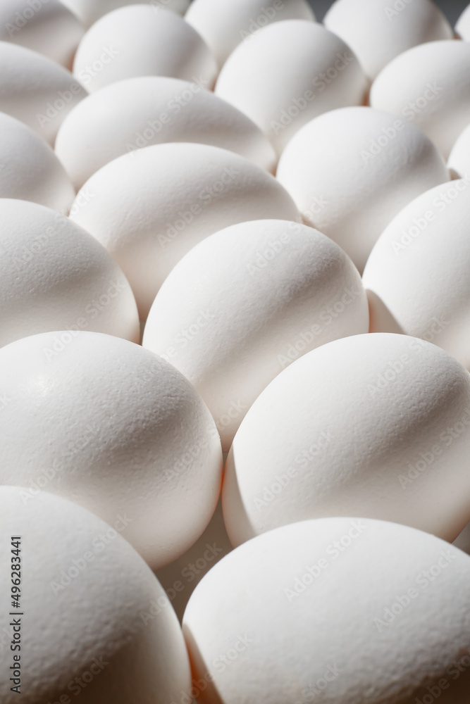 White eggs in a row. White eggs background. Shallow depth of field White eggs in a row. White eggs background. Shallow depth of field
