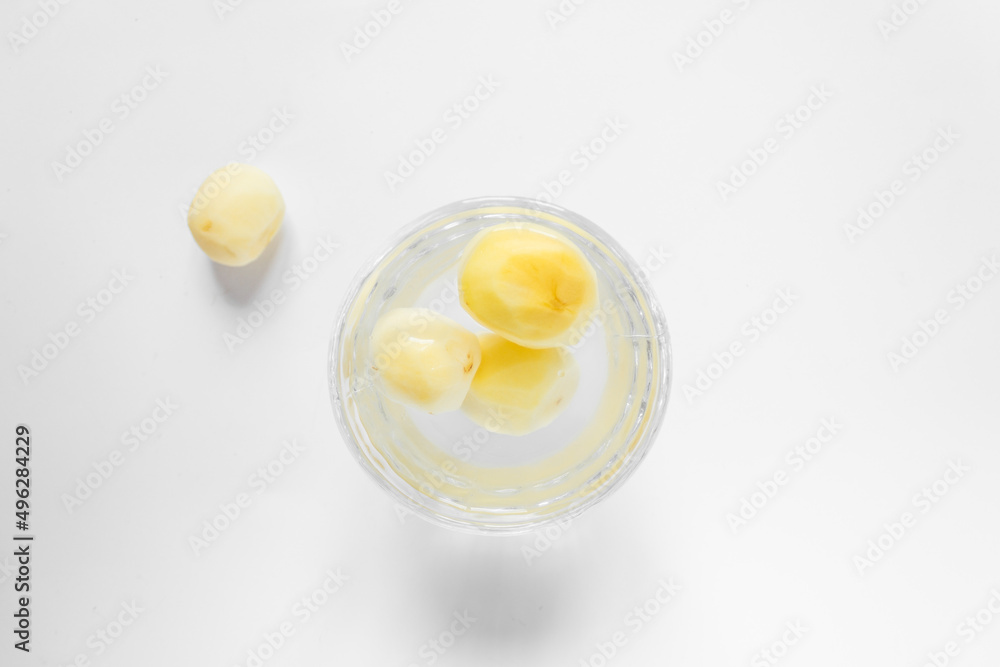 Top view of raw peeled potato vegetables in glass bowl of water. Isolated on white background. Top view of raw peeled potato vegetables in glass bowl of water. Isolated on white background.