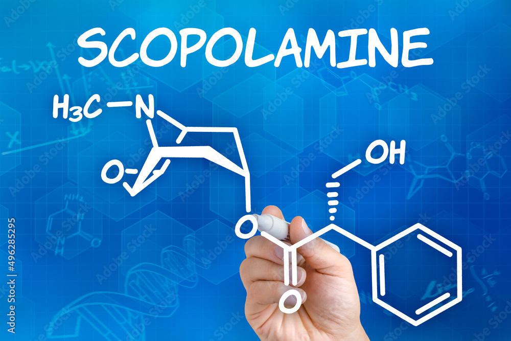 Hand with pen drawing the chemical formula of Scopolamine - obrazy, fototapety, plakaty 
