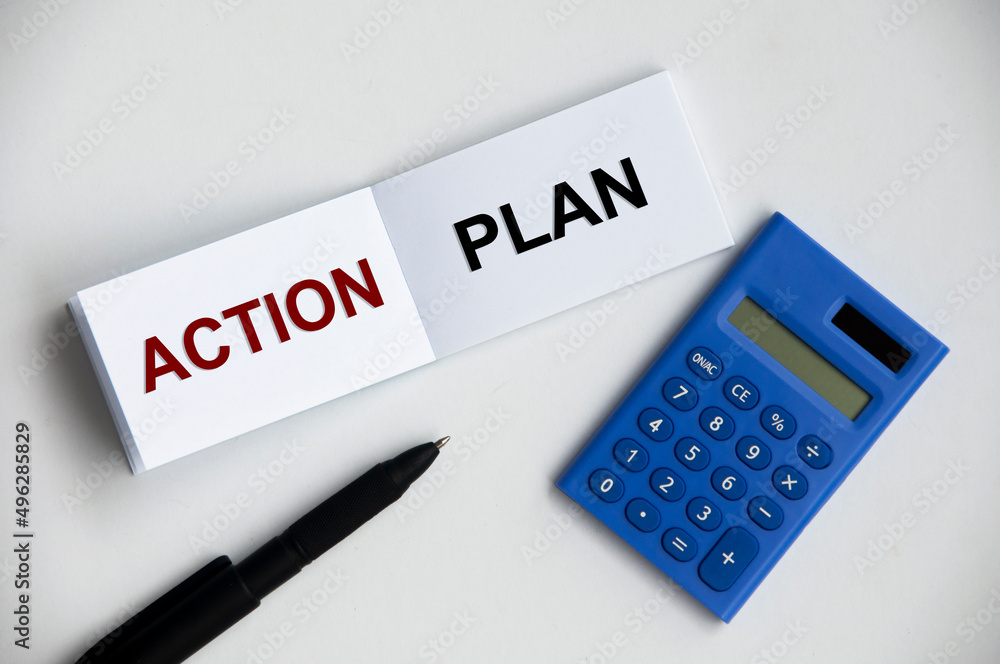 Action plan text on notepad with pen and calculator. Action plan text on notepad with pen and calculator.