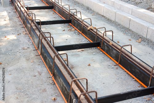 Tramway tracks with damping material coating