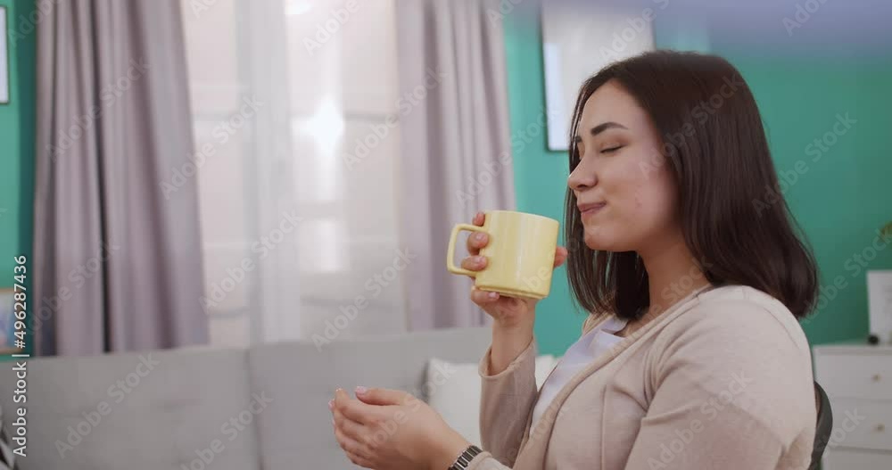 Close up portrait of cute student drinking coffe, looking at window and having break after working with computer, studying online with internet teacher, solving problem at home office. Close up portrait of cute student drinking coffe, looking at window and having break after working with computer, studying online with internet teacher, solving problem at home office.