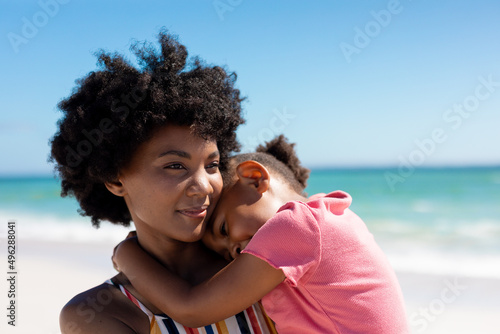 African american woman with daughter at beach enjoying summer weekend together