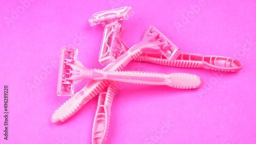 New pink disposable razors for safe shaving of female skin.Razor for smooth shaving. Sharp razors for personal hygienic routine. selective focus. 