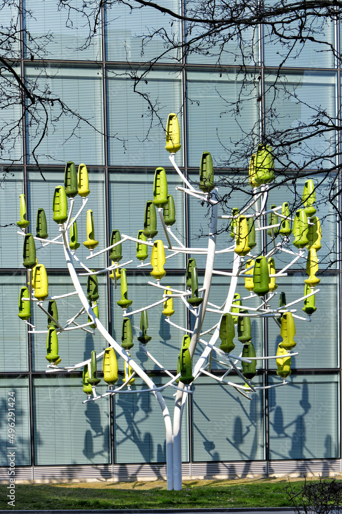 stylized tree with a steel trunk, equipped with a green plastic leaf functioning as so many silent mini-wind turbines in Geneva, Switzerland