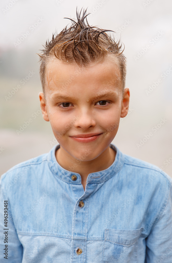 Smiling boy with stylish hairstyle outdoors after the rain. Looking at camera. Teenage portrait . Smiling boy with stylish hairstyle outdoors after the rain. Looking at camera. Teenage portrait .