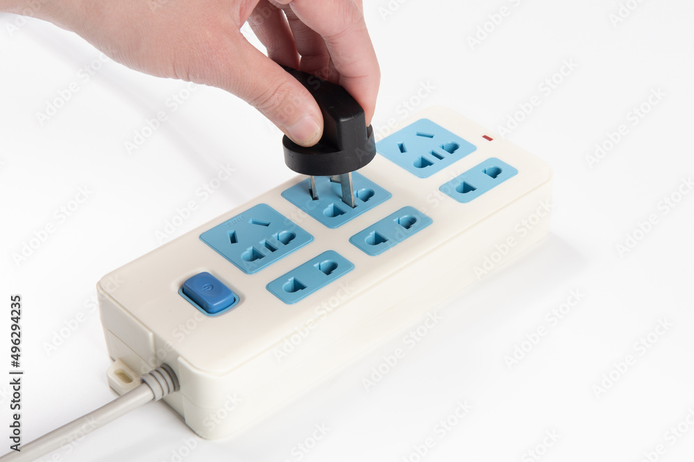 Hand holding Electric plug put on multiple socket. Hand holding Electric plug put on multiple socket.