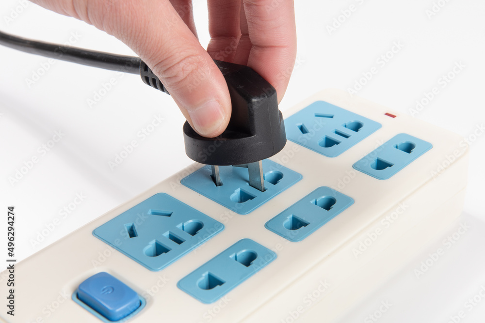 Hand holding Electric plug put on multiple socket. Hand holding Electric plug put on multiple socket.