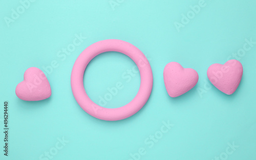 Fototapeta Naklejka Na Ścianę i Meble -  Pink ring with heart blue background. Minimal still life. flat lay. Love concept. Mock up