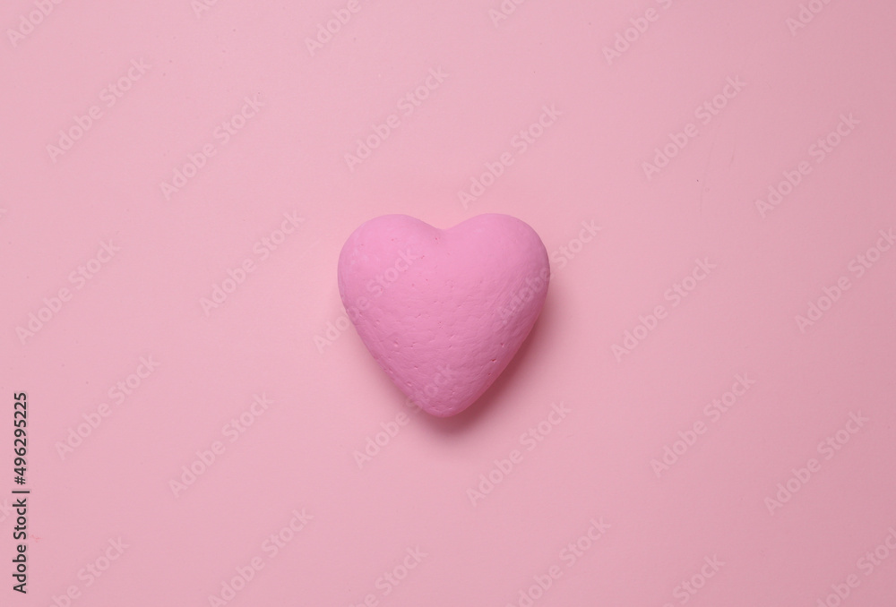 Fototapeta premium Pink heart on a pink background. Minimal love still life