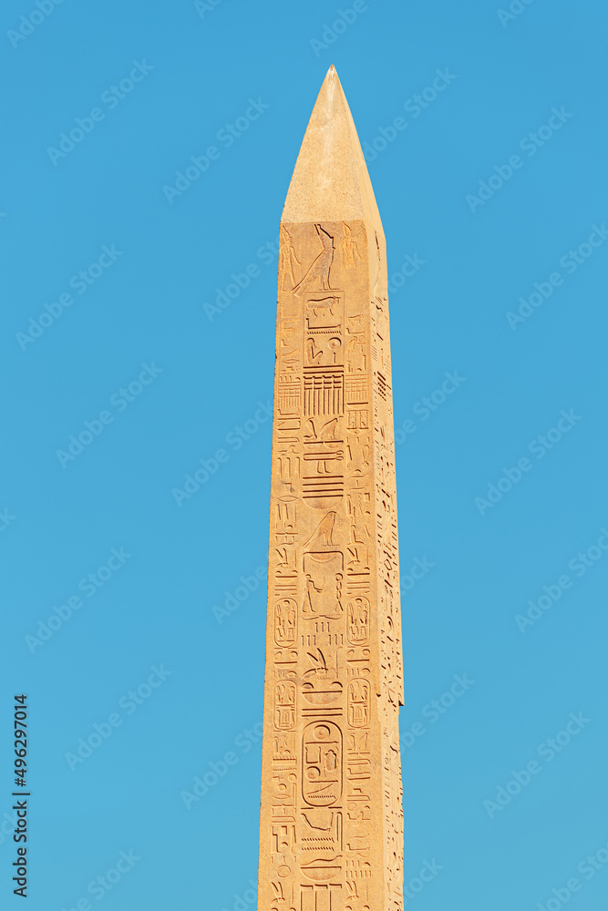 An obelisk with Egyptian carved hieroglyphs in Luxor. History and travel concept