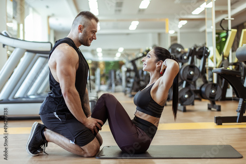Couple in love training in the gym. Healthy lifestyle. Abs workout
