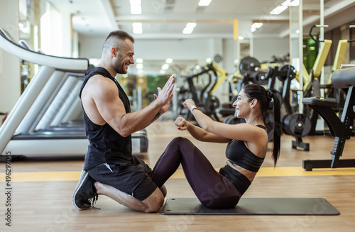 Couple in love training in the gym. Healthy lifestyle. Abs workout