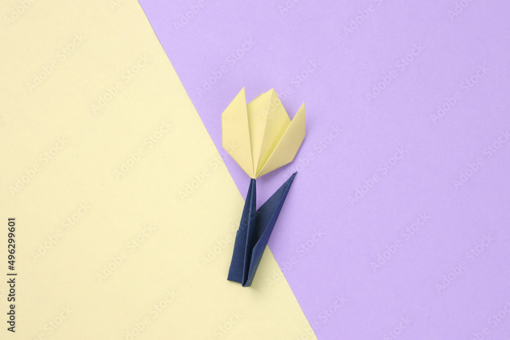 Pink paper tulip on colored pastel background. 8 March, women's day concept. Handmade origami tulip. Top view. Minimalism Pink paper tulip on colored pastel background. 8 March, women's day concept. Handmade origami tulip. Top view. Minimalism
