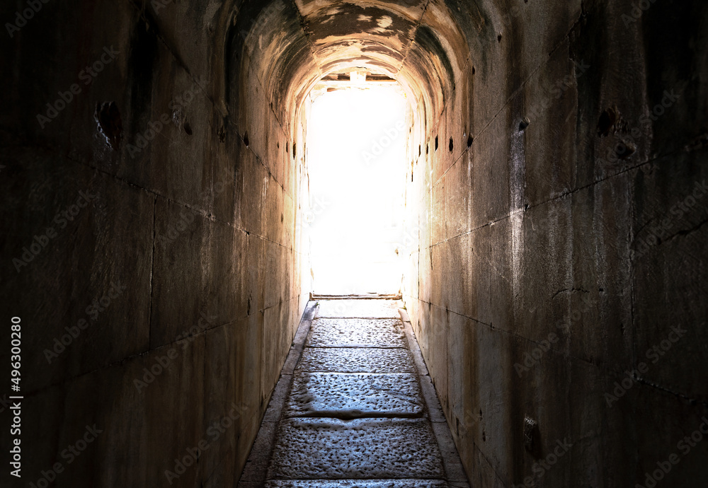 Narrow tunnel and shining bright light end of  darkness. Concept of hope heaven psychotherapy.