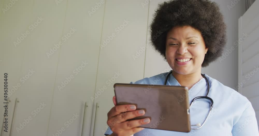 Video of happy plus size african american female doctor using tablet Video of happy plus size african american female doctor using tablet