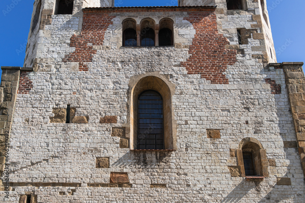 Facade, close-up of a medieval wall with windows of the Catholic Church in Old Krakow on a sunny day Facade, close-up of a medieval wall with windows of the Catholic Church in Old Krakow on a sunny day