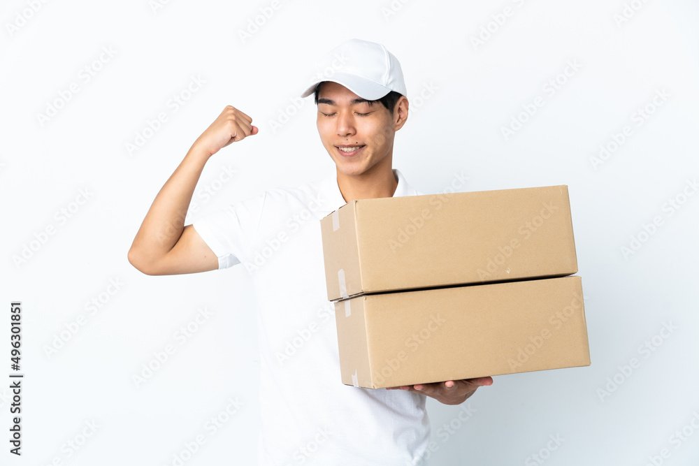 Delivery Chinese man isolated on white background doing strong gesture Delivery Chinese man isolated on white background doing strong gesture