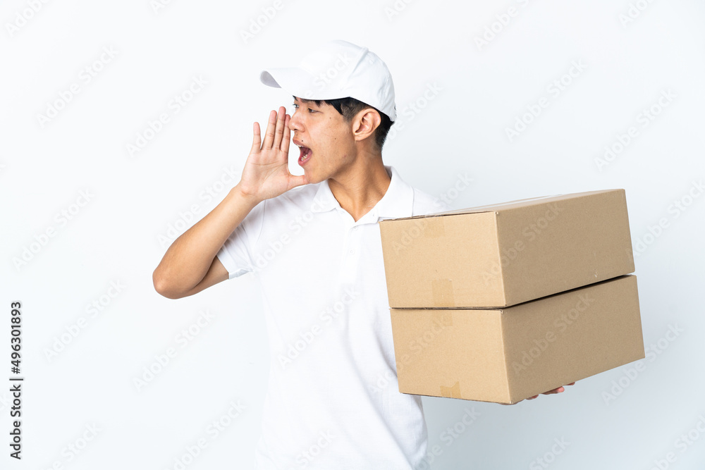 Delivery Chinese man isolated on white background shouting with mouth wide open to the side Delivery Chinese man isolated on white background shouting with mouth wide open to the side
