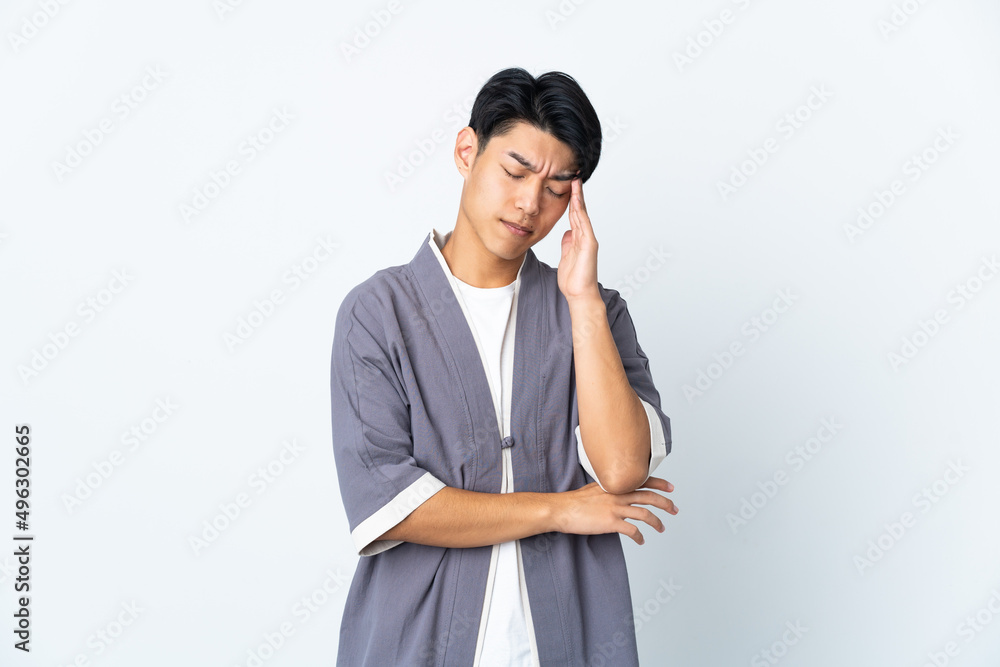 Young Chinese man isolated on white background with headache Young Chinese man isolated on white background with headache