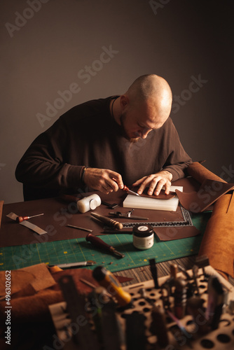 Photos Portrait of handsome tanner man at work, manual production, small business, authentic workshop, indoor