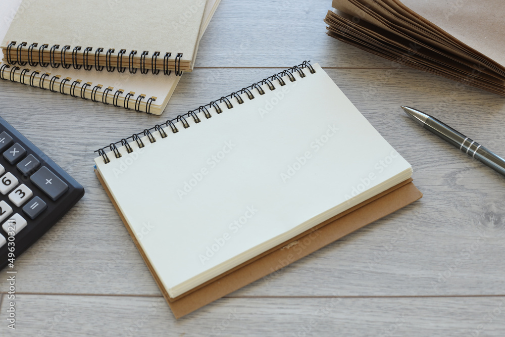 Flat lay, top view office desk. Workspace with white keyboard, open notepad with empty space on wooden background. Flat lay, top view office desk. Workspace with white keyboard, open notepad with empty space on wooden background.