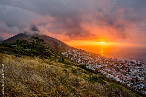 A dramatic sunset over Cape Town with the Lion's Head summit in clouds. photo