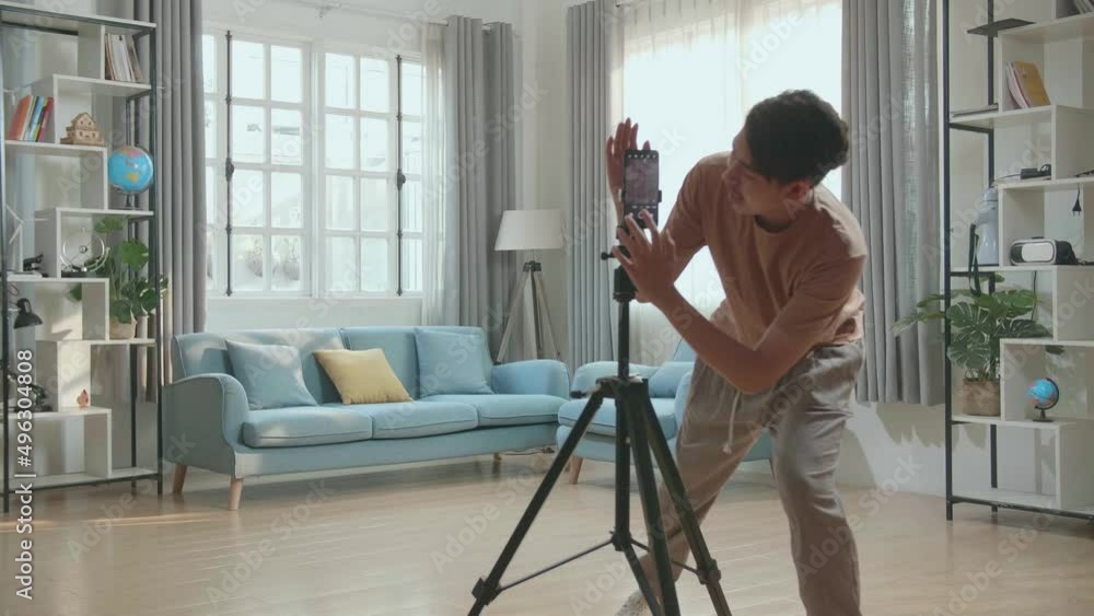 Asian Man Dancing While Shooting Video Content For Social Networks With A Smartphone Camera
Asian Man Dancing While Shooting Video Content For Social Networks With A Smartphone Camera