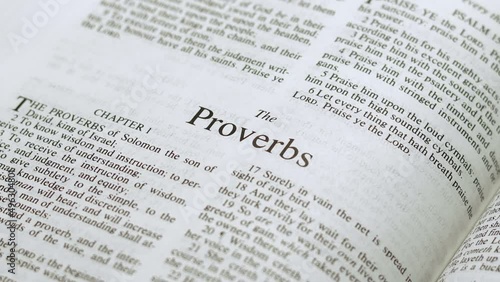 Close Up Shot of  Bible Page Turning to the book of Proverbs photo