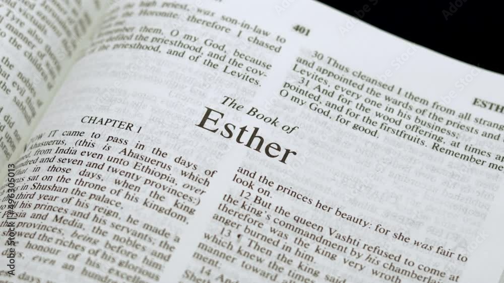 Close Up Shot of Bible Page Turning to the book of Esther Close Up Shot of Bible Page Turning to the book of Esther