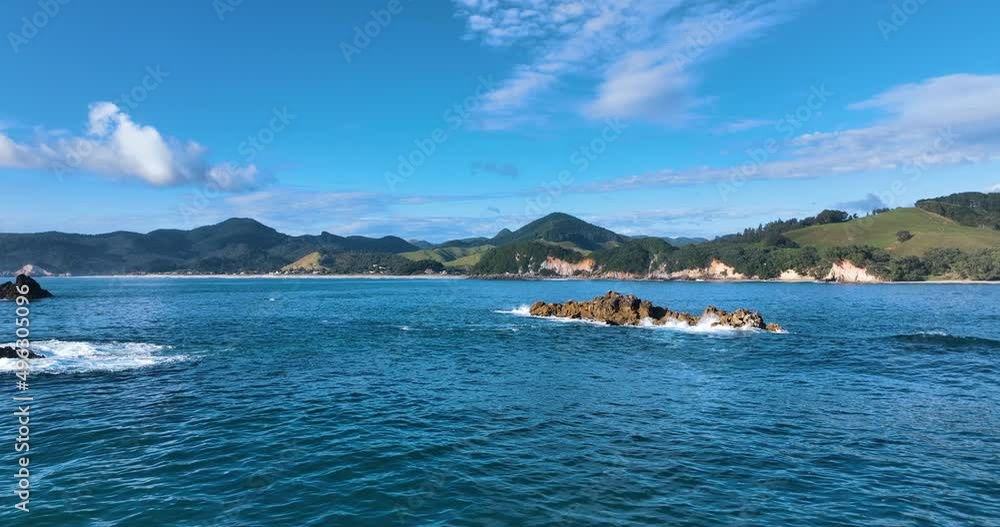 Aerial reverses close over waters surface and small craggy reef tops - NZ Aerial reverses close over waters surface and small craggy reef tops - NZ