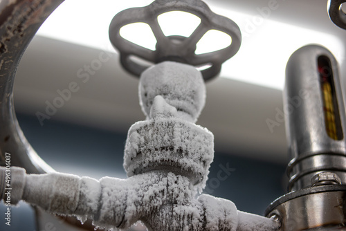 Frozen liquid nitrogen storage tank transfer valve. Close up shot, no people photo