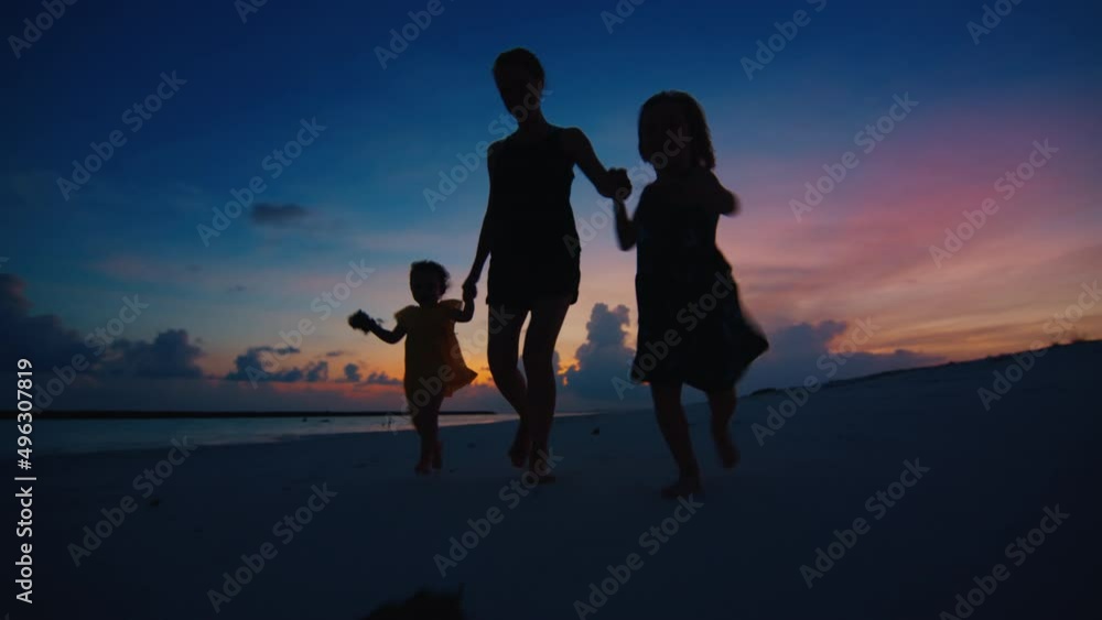 Family run on the tropical beach at sunset Family run on the tropical beach at sunset