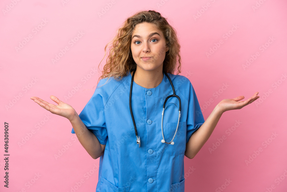 Young surgeon doctor woman isolated on pink background having doubts while raising hands Young surgeon doctor woman isolated on pink background having doubts while raising hands