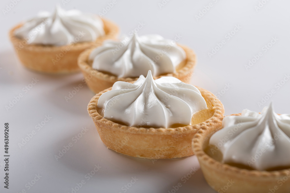 Close-up of a shortbread basket with cream and cherries. Production of pastries and cakes. Close-up of a shortbread basket with cream and cherries. Production of pastries and cakes.
