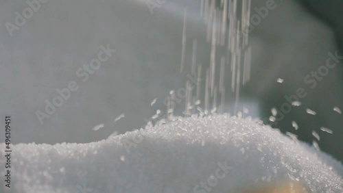 Polypropylene granules. Falling polypropylene granules, slow motion. Polypropylene granules close-up. Nonwoven Fabric Factory photo