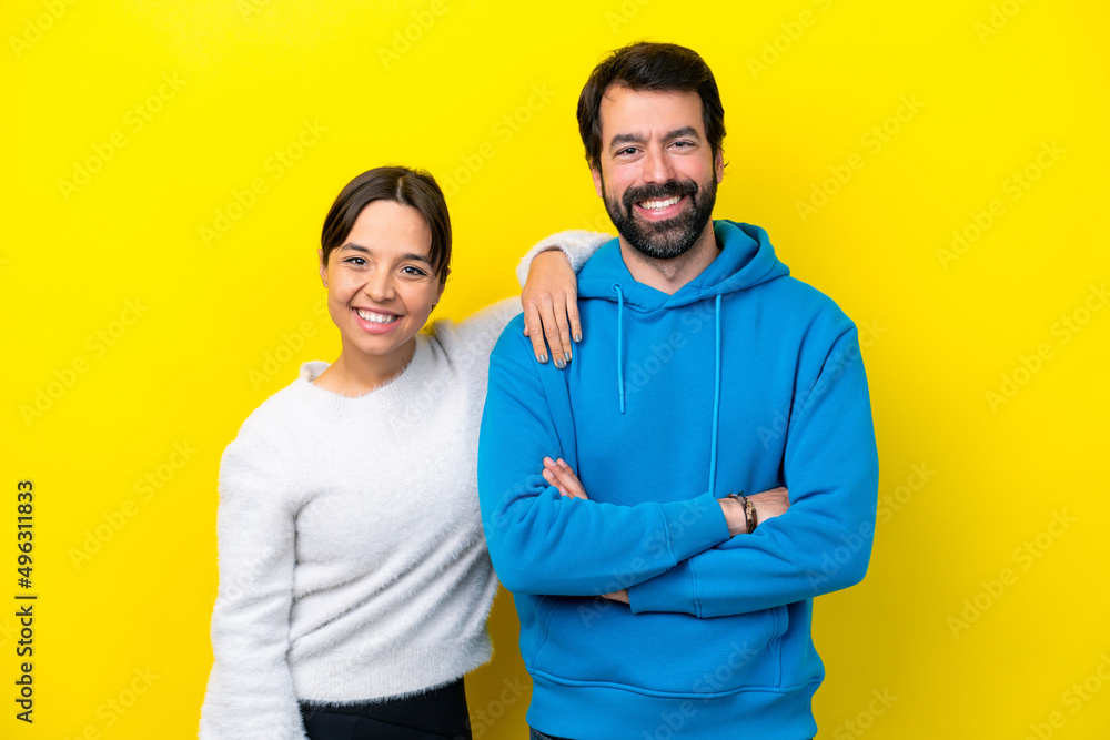 Young caucasian couple isolated on yellow background happy and laughing Young caucasian couple isolated on yellow background happy and laughing