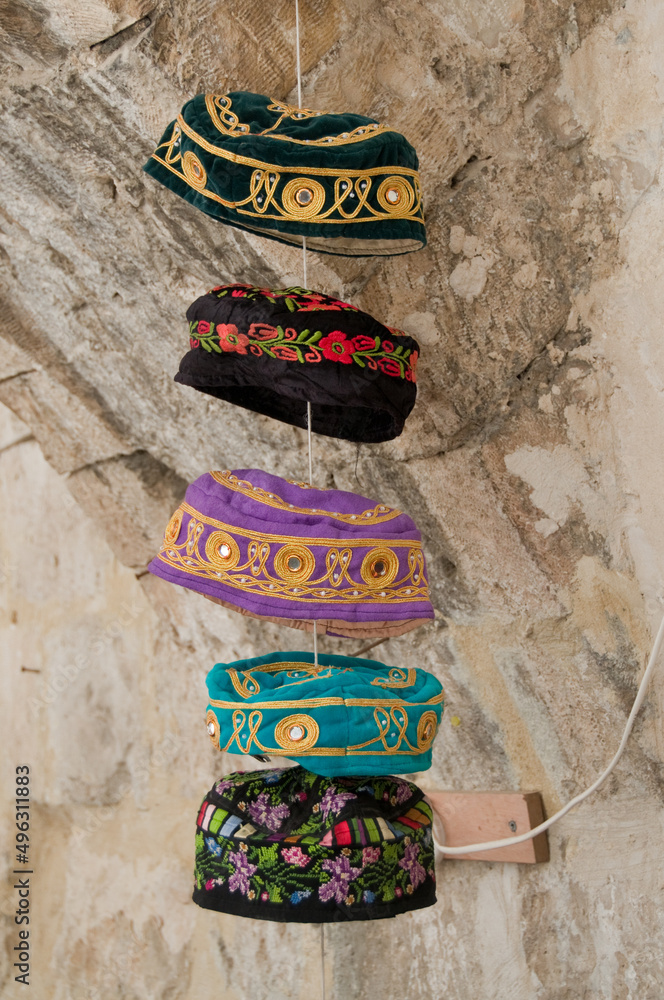 Colorful head coverings traditionally worn by bukharan Jews hang on a
